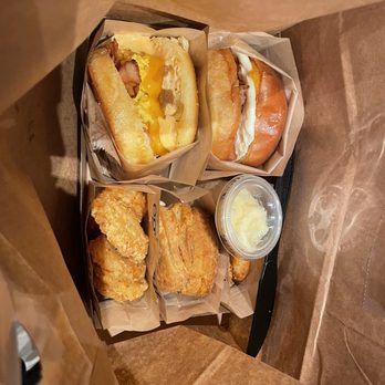 Eggslut - (Top left clockwise) Fairfax with gluten free bread and bacon, Bacon, Egg & Cheese, two truffle hash browns, and Buttermilk Biscuit - Breakfast & Brunch Near Me - Las Vegas, Nevada