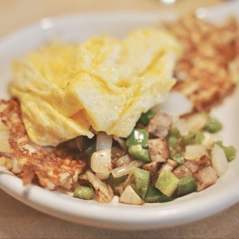 Country Kitchen - Farm Skillet. A hearty plate of eggs over a bed of seasoned hash browns, mingling with chopped sausage, onion, and green peppers. - New American Near Me - Big Bear Lake, California