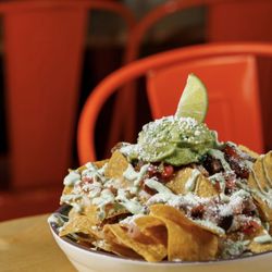Tacos El Chikis - Loaded nachos with choice of protein.