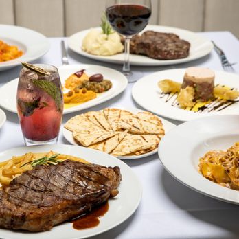 Skinos - Dry Aged Rib Eye Steak (Left) & Duck Pappardelle (Right) - Greek Near Me - New York, New York Skinos - Dry Aged Rib Eye Steak (Left) & Duck Pappardelle (Right) - Greek Near Me - New York, New York