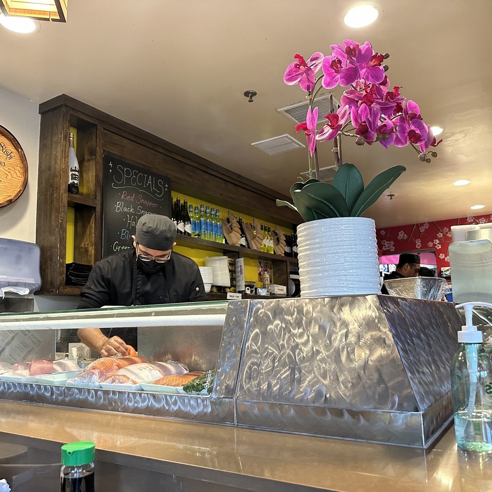 Crazy Rock'N Sushi - a man behind the counter - Sushi Bars Near Me - Irvine, California Crazy Rock'N Sushi - a man behind the counter - Sushi Bars Near Me - Irvine, California