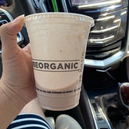 a hand holding a cup of organic coffee a hand holding a cup of organic coffee