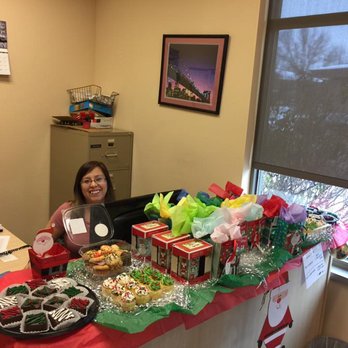 Grakei Maids - Our Office Assistant, Claira, surrounded by cupcakes and Christmas presents :) - Home Cleaning Near Me - Madison, Wisconsin
