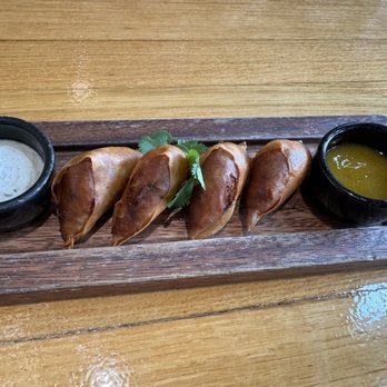 Traveler's Table - CRAB SAMOSAS Flaky curried crab pastry, raita, spicy mango chutney $18 - Cocktail Bars Near Me - Houston, Texas