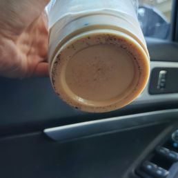 Iced caramel latte full of grounds.