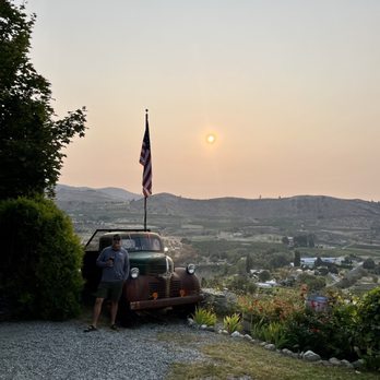 Four Lakes Winery - a man standing next to an old car - Wineries Near Me - Manson, Washington Four Lakes Winery - a man standing next to an old car - Wineries Near Me - Manson, Washington