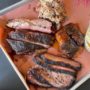 Interstellar BBQ - Clockwise from top left: St. Louis pork ribs, smoked lamb shoulder, peach tea glazed pork belly, brisket - Barbeque Near Me - Austin, Texas