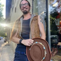 Rezened - Daniel modeling a vest and hat from ReZENed