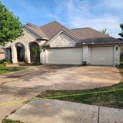 Positive Results Power Washing - Exposed aggregate driveway cleaned. Before and after.