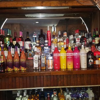 Osmino's Grill - a shelf full of alcohol bottles - Pizza Near Me - New London, Connecticut