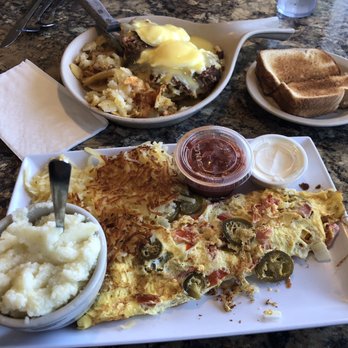 Mamas Kitchen - Tex-Mex Omelette, Hash Browns, toast and a side of grits front, Crabcake Benedict platter, home fries rear. - Breakfast & Brunch Near Me - Seminole, Florida Mamas Kitchen - Tex-Mex Omelette, Hash Browns, toast and a side of grits front, Crabcake Benedict platter, home fries rear. - Breakfast & Brunch Near Me - Seminole, Florida