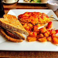 Bernard’s Cafe - Spanish omelet with home fries and multi-grain toast. Delicious omelet; ketchup was added by me.