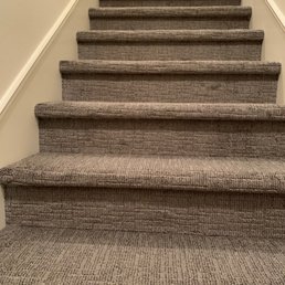Beautifully installed grey, textured carpet on the stairs