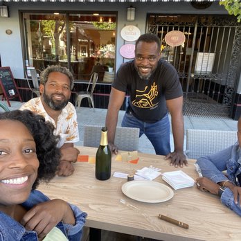 Karibu By Wachira - One of The Greats (standing) and my crew (seated)...post indoor tasting. - Wine Tasting Room Near Me - Alameda, California Karibu By Wachira - One of The Greats (standing) and my crew (seated)...post indoor tasting. - Wine Tasting Room Near Me - Alameda, California