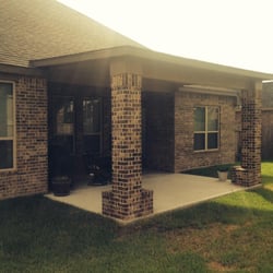 Ziegler Construction - Patio extension- flat roof with 30 year shingle and brick columns.