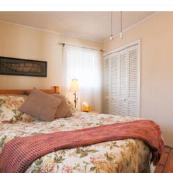 The River Roost Vacation Rental - Queen bedroom with extra pillows and blanket in the closet. Hangers provided