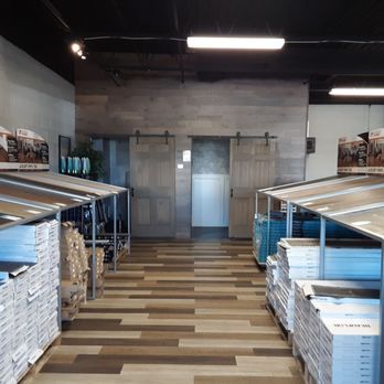 Overstock Flooring - The first aisle, on the left as you enter; a selection of faux wood flooring. - Flooring Near Me - Rochester, New York