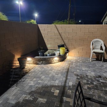 Luxurious Lawn Maintenance - a patio with a fire pit - Landscaping Near Me