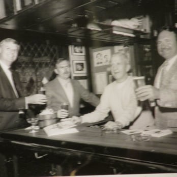 Cheers - ole b&w photos on wall of famous people who must have hung around in this place at some time - American Near Me - Boston, Massachusetts