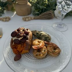 On The Go Gourmet - Marinated shrimp and chicken skewers with loaded sweet potatoes with roasted grapes and goat cheese.