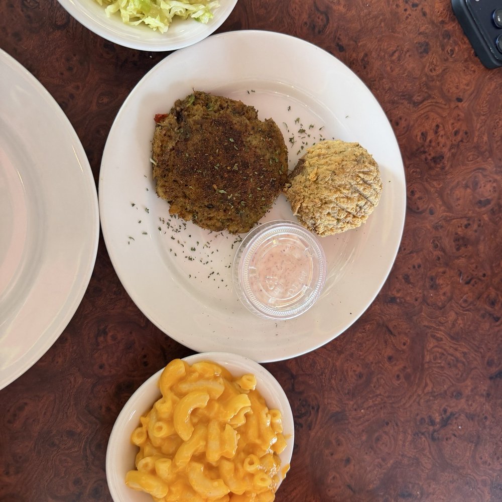 Crab cakes , one blackened and one fried with Mac and cheese and coleslaw Crab cakes , one blackened and one fried with Mac and cheese and coleslaw