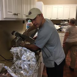 Beasley Drug - Carving smoked turkey for "In His Name Thanksgiving Feast."