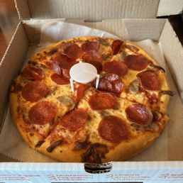 Small round pepperoni and sausage pizza. Small round pepperoni and sausage pizza.
