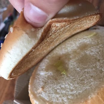 McDonald's - a hand holding a half eaten sandwich - Burgers Near Me - South Portland, Maine McDonald's - a hand holding a half eaten sandwich - Burgers Near Me - South Portland, Maine