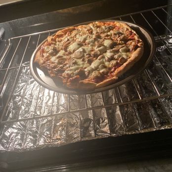 Falco's Pizza - Pizza baking in my oven because the canned mushrooms looked like they were thrown on just before boxing the pizza. - Pizza Near Me - Chicago, Illinois Falco's Pizza - Pizza baking in my oven because the canned mushrooms looked like they were thrown on just before boxing the pizza. - Pizza Near Me - Chicago, Illinois