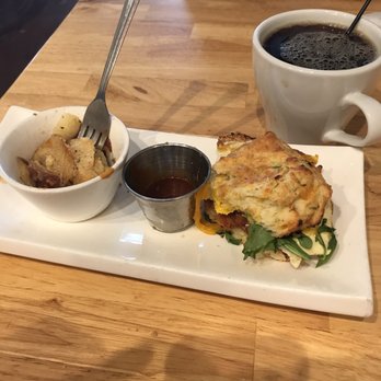 Cure Coffeehouse - Jalapeño cheddar biscuit with fried egg and bacon. Side of potatoes with the house BBQ sauce in the middle (the sauce is fantastic). - Coffee & Tea Near Me - Norfolk, Virginia Cure Coffeehouse - Jalapeño cheddar biscuit with fried egg and bacon. Side of potatoes with the house BBQ sauce in the middle (the sauce is fantastic). - Coffee & Tea Near Me - Norfolk, Virginia