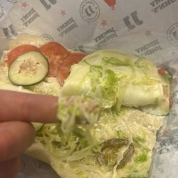 Jimmy John's - Slimy lettuce, stale and slimy sandwich, photo taken right after it was delivered nearly 2 hours after I ordered it