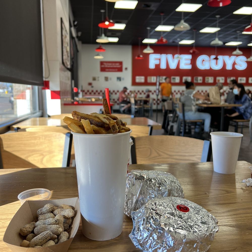Five Guys - a table with food and a cup of coffee - Burgers Near Me - Kalispell, Montana Five Guys - a table with food and a cup of coffee - Burgers Near Me - Kalispell, Montana