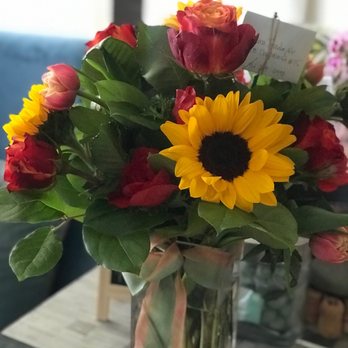 Riley's Flowers - Beautiful floral arrangement containing sunflowers, orange/red roses and other beautiful flowers I wish I knew the names. - Florists Near Me - Santa Barbara, California Riley's Flowers - Beautiful floral arrangement containing sunflowers, orange/red roses and other beautiful flowers I wish I knew the names. - Florists Near Me - Santa Barbara, California