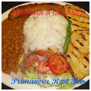 Primavera Restaurant - Grilled chicken breast (pechuga a la parilla) served with white rice, red or black beans salad - Latin American Near Me - Brooklyn, New York