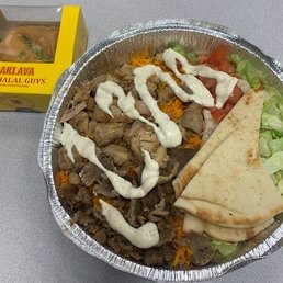 Mixed meat platter with a side of baklava.