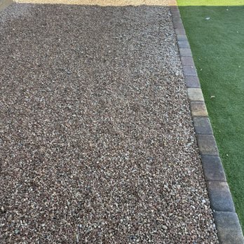 Bud's Affordable Landscaping - After completion, paver wall between rocks and turf looks great! - Landscaping Near Me