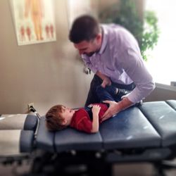 Affinity Family Chiropractic - Dr. Matt carefully adjusting his son, Harrison when he was three years old.