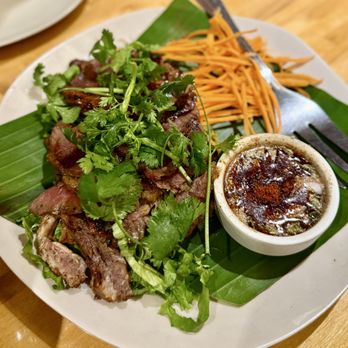 Manaow - Crying Tiger (Seur Rong Hai) ($18) Marinated grilled Rib-Eye steak. Served on a bed of lettuce with jaew sauce - Thai Near Me - Long Beach, California Manaow - Crying Tiger (Seur Rong Hai) ($18) Marinated grilled Rib-Eye steak. Served on a bed of lettuce with jaew sauce - Thai Near Me - Long Beach, California