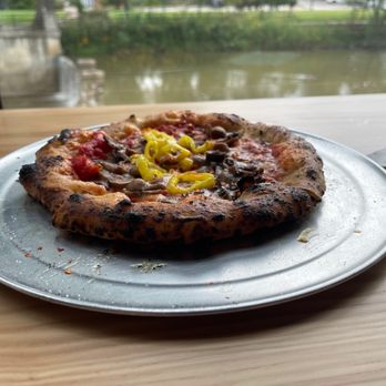 ETalian - a pizza on a plate on a table - Pizza Near Me - Chagrin Falls, Ohio