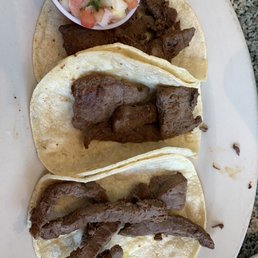 This is the three carne asada tacos . They were very dry.Almost like beef jerky. As you can see , those are some very sad looking tacos.