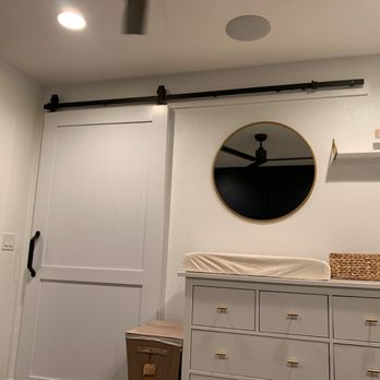 Abner G - a white dresser with a mirror and a clock on the wall - Handyman Near Me