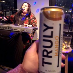 a person holding a can of truly a person holding a can of truly