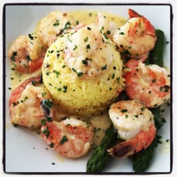 Beautiful saffron rice and generous size of garlic prawns with cream sauce Beautiful saffron rice and generous size of garlic prawns with cream sauce
