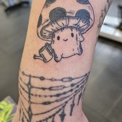Electric Mayhem Tattoo - Medium sized mushroom tattoo guy holding a watering can