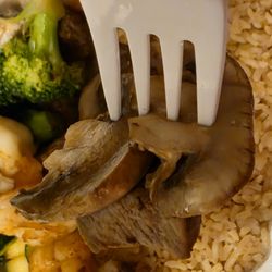 Hibachi Express Japanese Restaurant - Close-up of a fork holding a piece of Filet Mignon and mushrooms.