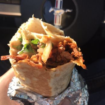 Taco Rapido - a hand holding a burrito - Tacos Near Me - Fresno, California Taco Rapido - a hand holding a burrito - Tacos Near Me - Fresno, California