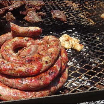 Mr Pork - Sausage cooking on the grill, along with sirloin steak and chicken.  How did I choose?  I simply didn't... as it was simply sausage. - Caterers Near Me