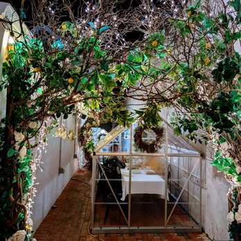 ITA Kitchen - a table set up with flowers and greenery - Italian Near Me - Bay Shore, New York