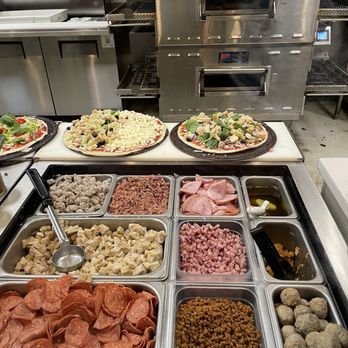Pieology Pizzeria - Pies ready to be cooked! The one on the right is a cauliflower crust and the one on the left is regular thin crust. - Pizza Near Me - Winter Garden, Florida