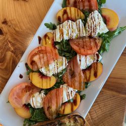 Pesto Italian Craft Kitchen - Peach and heirloom tomatoes with burrata cheese.